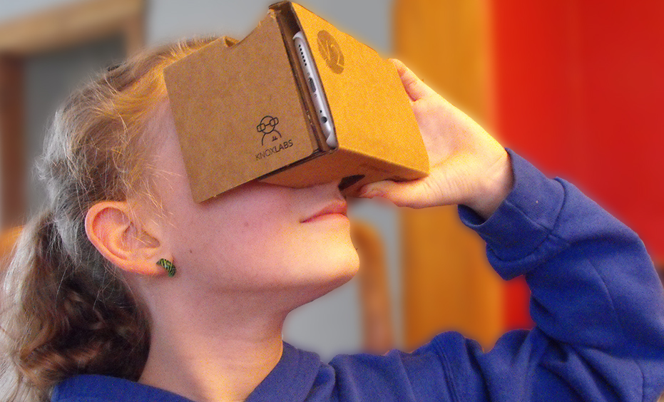 child looking into cardboard 3D viewer