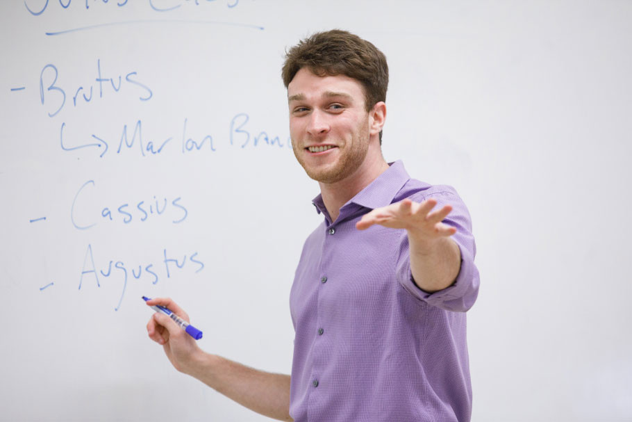 Faculty member explaining what he wrote on the white board.