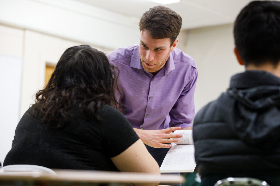 Faculty member discussing class materials with student.